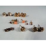 9 ct - six pairs of predominantly 9 carat gold earrings plus a miniature 9 carat gold brooch in a