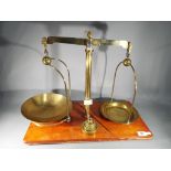 Weighing Scales - a vintage set of pharmacist or dispensary balance scales on rectangular wooden