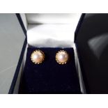 A pair of 9 carat gold and pearl earrings in presentation box stamped 375 (hallmarked)