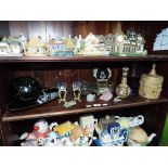 A shelf containing a quantity of miscellaneous glass and crystal to include a crystal animal,