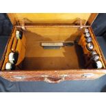 An early 20th century crocodile travelling dressing case by the North West Tanner and Co Limited