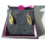 A pair of 9 carat gold and silver drop leaf earrings