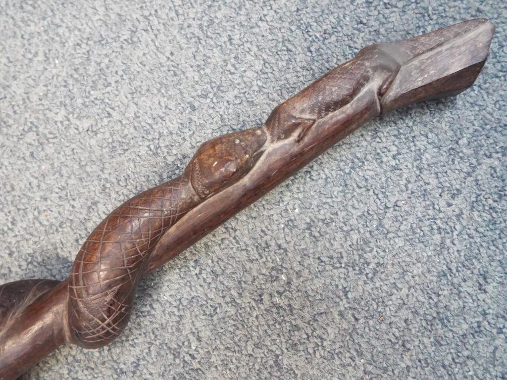 An African hardwood carved tribal staff or totem depicting a snake eating a lizard along the length, - Image 2 of 5