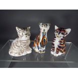 Royal Crown Derby - three paperweights depicting cats to include 'Thomas' gold coloured button