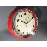 A retro style wall clock with quartz movement, red case, unused,