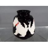 Moorcroft Pottery - a small vase decorated with depictions of Westie dogs,