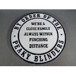 A cast circular wall sign 'Peaky Blinders',