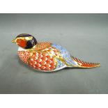 A Royal Crown Derby paperweight in the style of a pheasant,