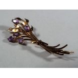 9 ct - a hallmarked 9* carat gold and brooch in a form of bouquet set with five amethyst in