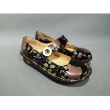 Alegria - a pair of Alegria patent leather shoes with a floral design by PG Lite,