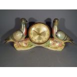 A West German mantel clock set in a ceramic display depicting two pigeons by Jema Holland.