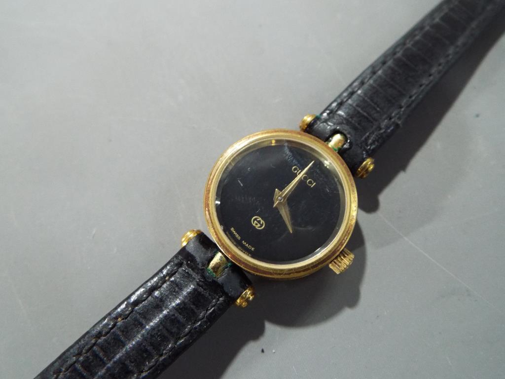 Gucci - a lady's designer Gucci Swiss made wristwatch with leather strap black Gucci face with - Image 2 of 3