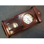 A mahogany cased wall clock, Arabic numerals to the dial, with pendulum.