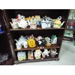 Tea Pots - a large quantity of tea pots and other (over three shelves)