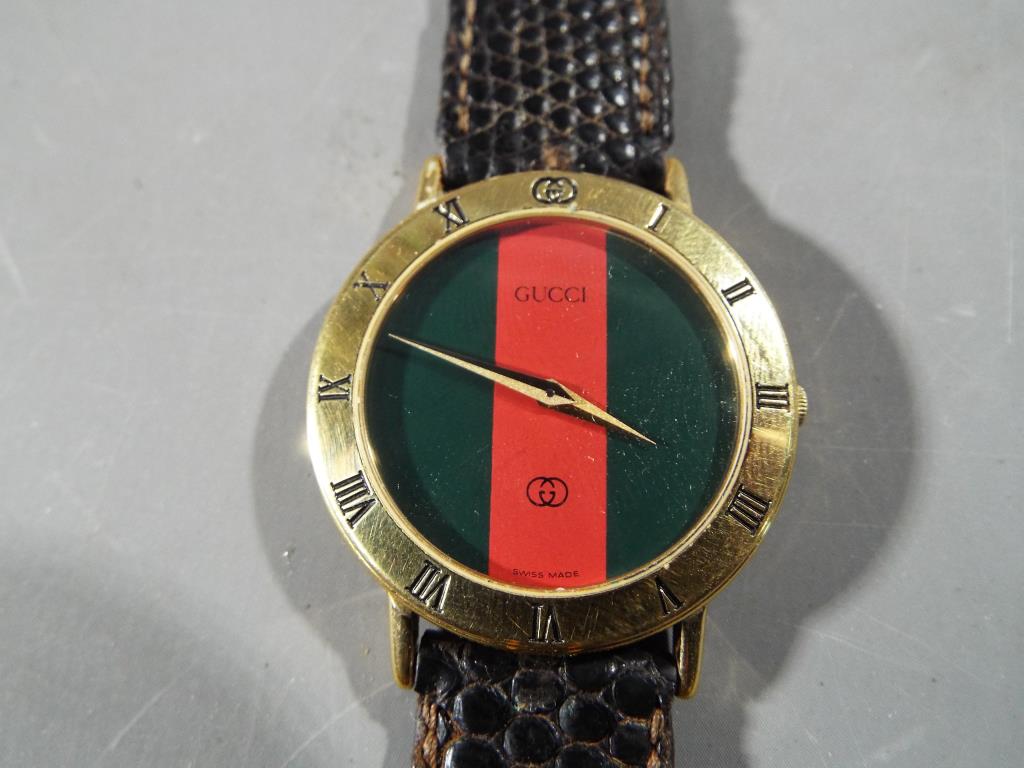 A Gucci wristwatch in presentation case.