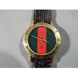 A Gucci wristwatch in presentation case.