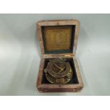 A brass sundial / compass marked J W Steward