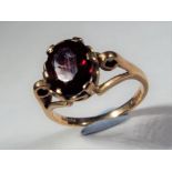 9 ct - a 9 carat hallmarked yellow gold ring with large ruby center stone,