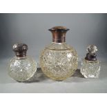 Three silver mounted scent bottles, assay marks unclear,