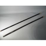 Two ebony walking canes of which one with hallmarked silver mount,