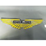 A cast promotional sign marked Aston Martin,