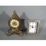 A Splendex mantel clock and one other.