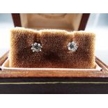 18 ct - a pair of 18 carat white gold diamond solitaire earrings,