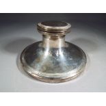 An Edward VII silver hallmarked capstan inkwell with hinged lid and glass vessel,