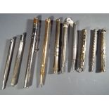Writing Instruments - A collection of ten white metal and plated propelling pencils,