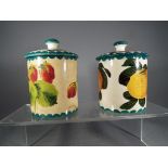 Wemyss Ware - two Wemyss preserve pots with covers 'Strawberry', signed 'Wemyss' to the base,