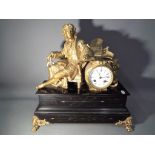 A late 19th century French black marble and gilded spelter mantel clock raised on four lions paw
