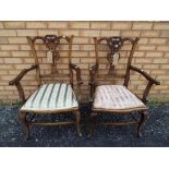 A pair of Edwardian armchairs with upholstered seats and carved backs [2]