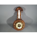 A Victorian carved aneroid barometer,