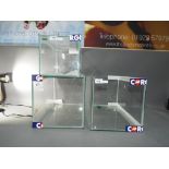 Three glass display cases, the largest a