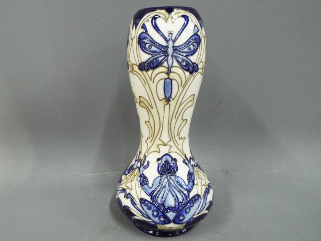 Moorcroft Pottery - a tall vase decorate