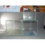 Three glass display cases, the largest a