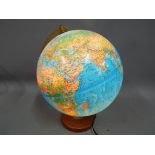 A modern Replogle, illuminating terrestrial globe on wooden base.