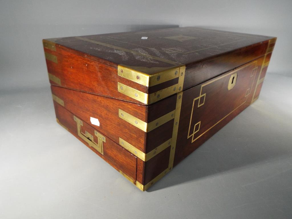 A mahogany and brass bound campaign writing slope with flush brass handles with one end having - Image 2 of 4