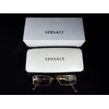 A pair of Versace eyeglasses, model number 1143b, marked 4916 to the bridge,