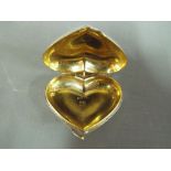 A continental 800 silver pill box in the shape of a heart.