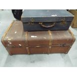 A shipping trunk with rope handles,