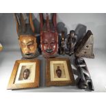 A collection of tribal masks and carvings.