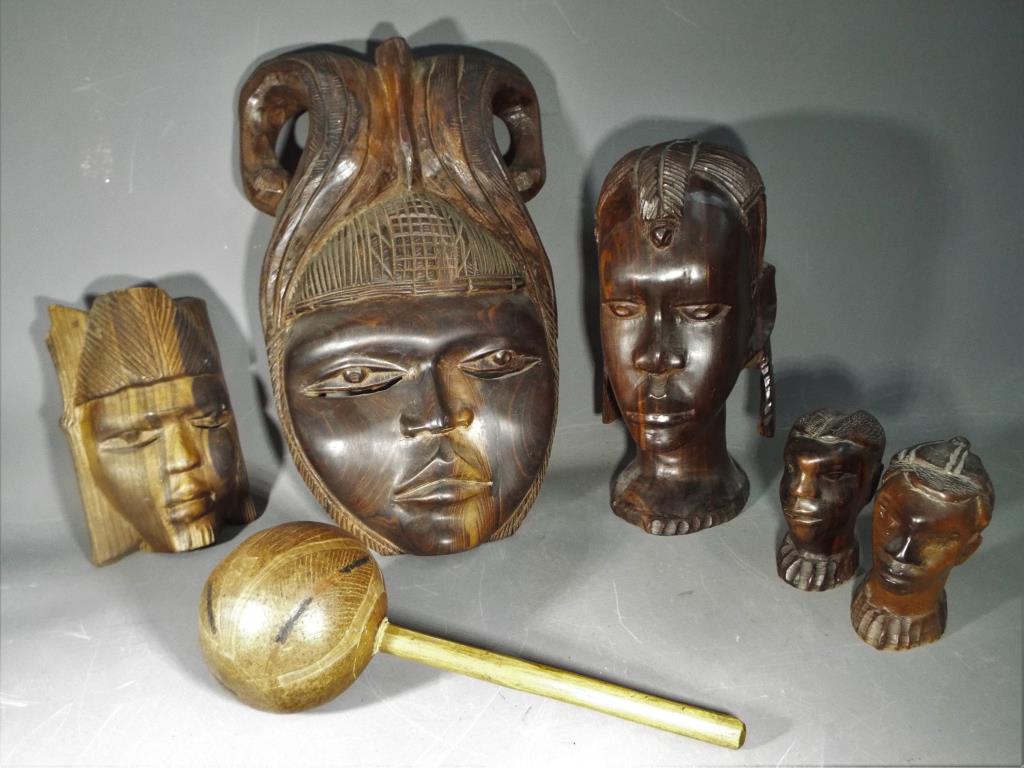 A quantity of hardwood tribal masks and carvings.