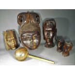 A quantity of hardwood tribal masks and carvings.