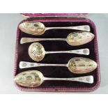 A cased Victorian set of four silver hallmarked dessert serving spoons and sifter,