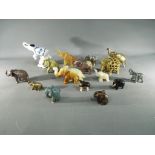 A herd of carved elephants to include stone, brass, wooden and similar.