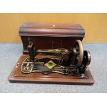 A vintage Jones Family Sewing Machine in wooden case.