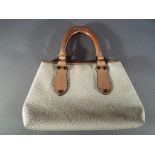 A Lady's good quality occasional bag with leather tan straps,