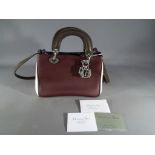 A good quality leather triple coloured small day bag marked Christian Dior Paris Made in Italy with