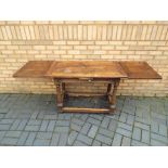 A solid oak dining table with two leaf extender approximate height 75 cm x 105 cm,